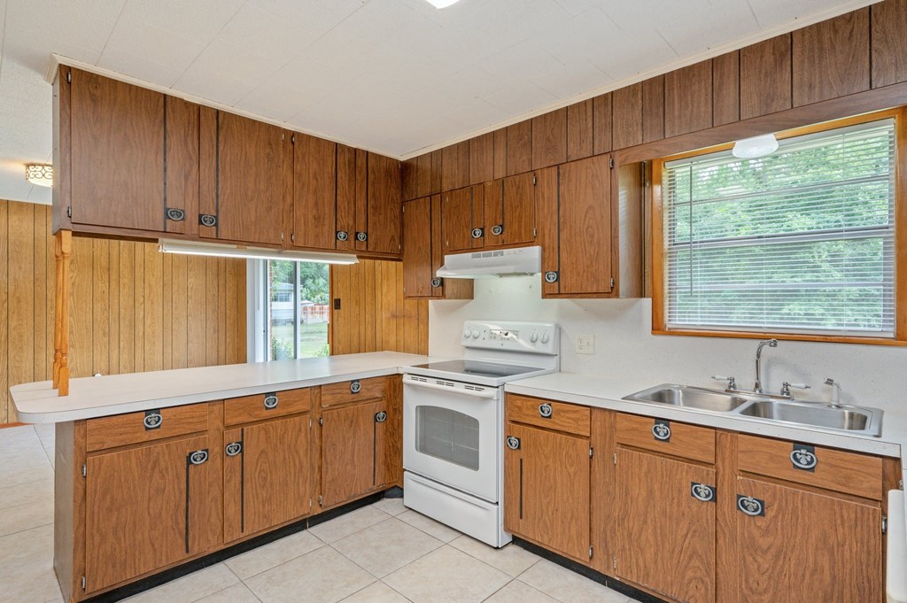 a kitchen with white appliances and wooden cabinets