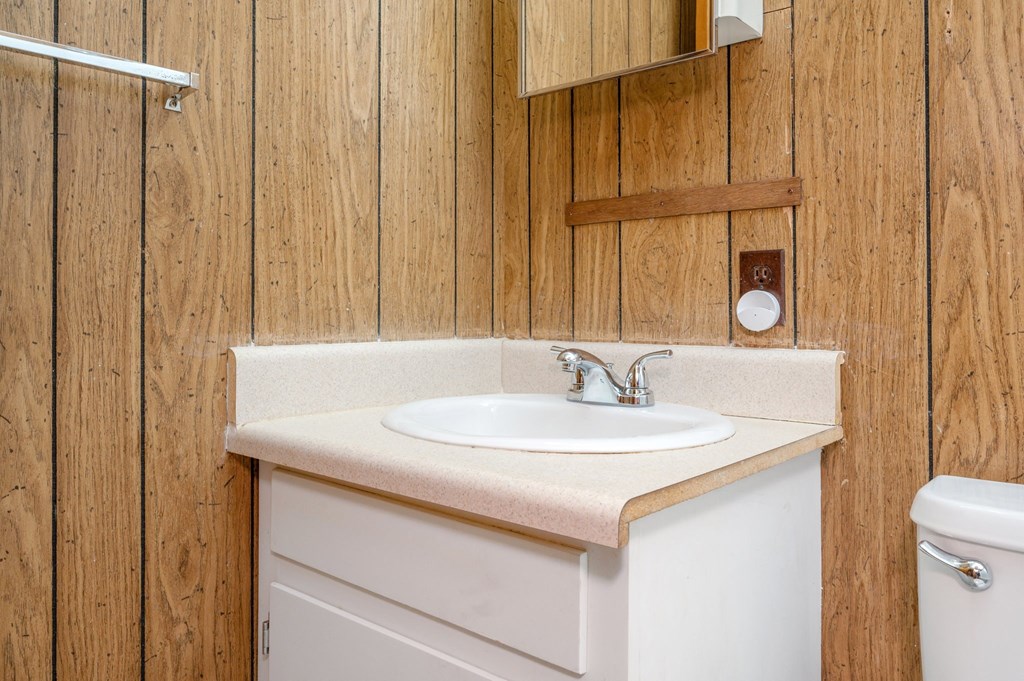a small bathroom with a sink and a mirror