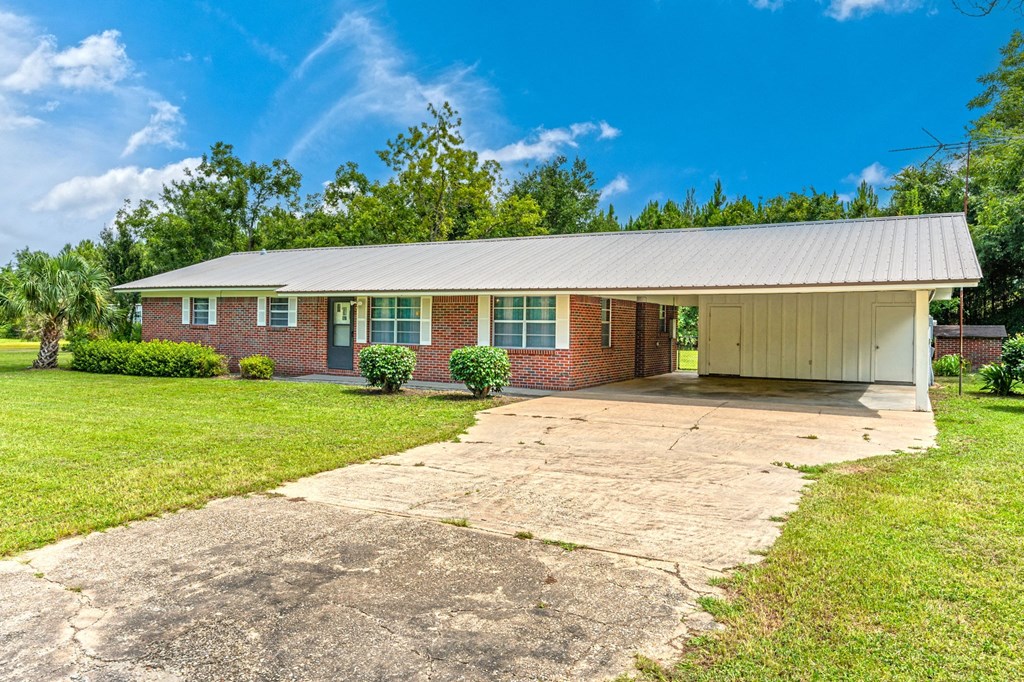 a brick house with a garage and a driveway