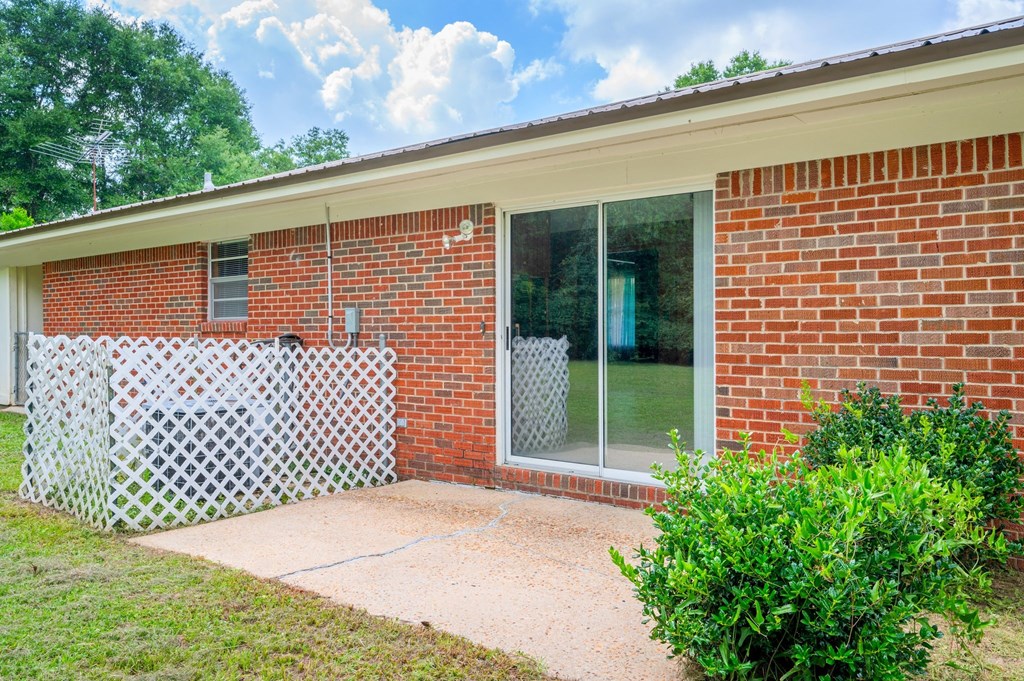 a brick house with a patio and a sliding glass door