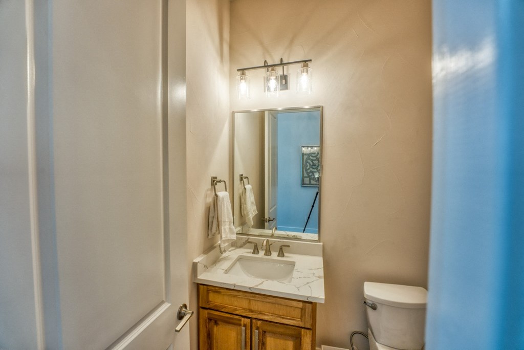 a bathroom with a sink and a mirror and a toilet