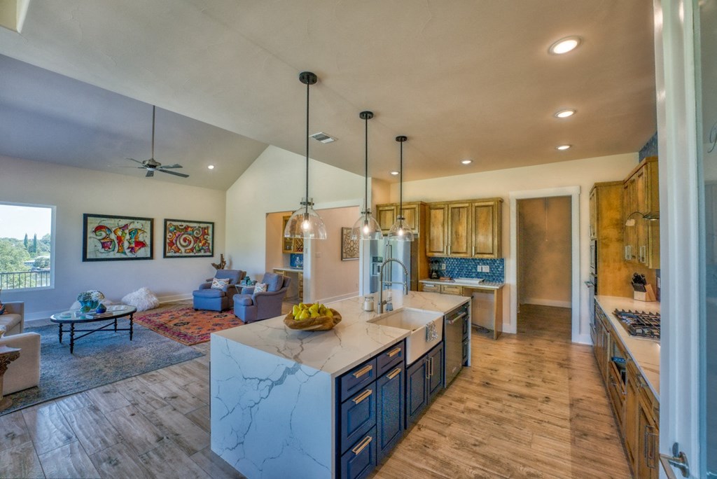 a kitchen with blue cabinets and a marble counter top