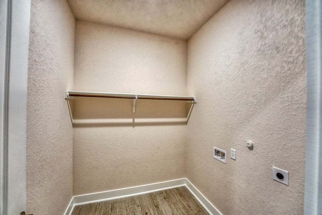 a empty room with a closet and a mirror