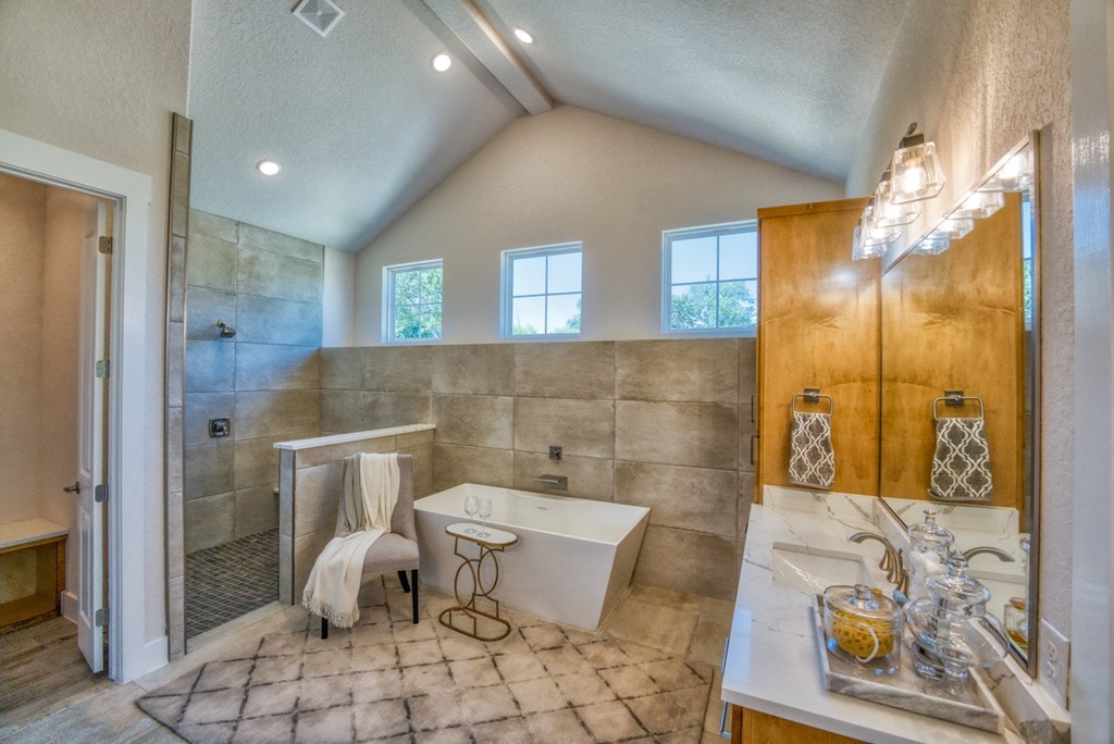 the master bathroom has a soaking tub and a walk in shower