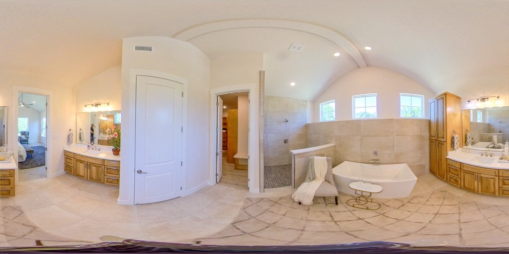 a large bathroom with a tub and a sink and a shower