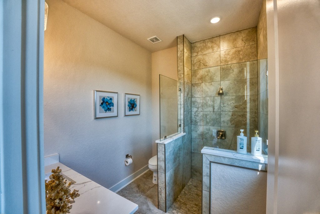 a bathroom with a shower and a sink and a toilet