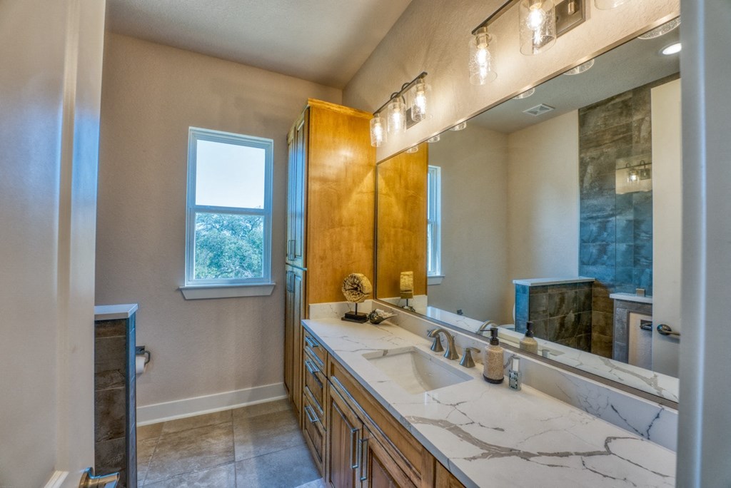 a bathroom with a sink and a mirror and a shower