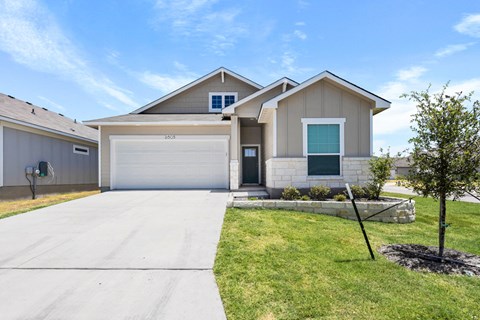 a house with a white garage door and a driveway
