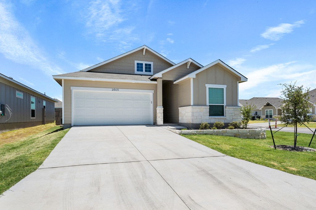 a house with a driveway and a garage door