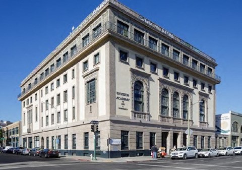 a large building on the corner of a city street