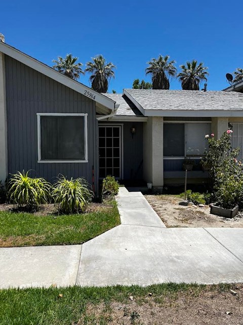 a house with a sidewalk in front of it