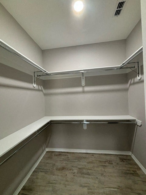 a empty room with white walls and a wood floor