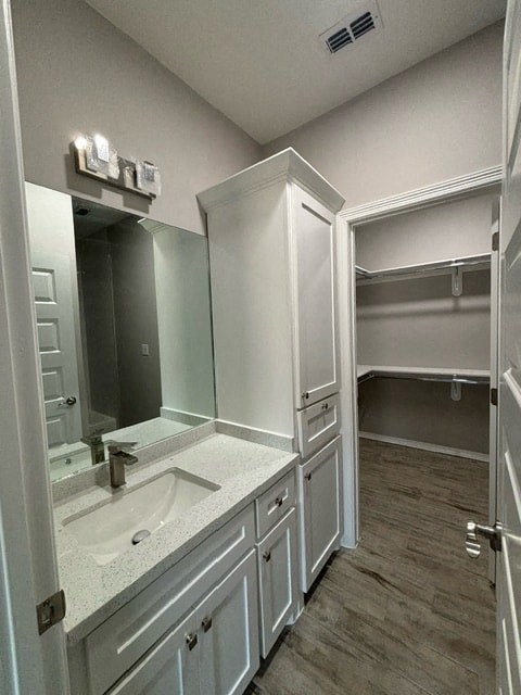 a white bathroom with a sink and a mirror
