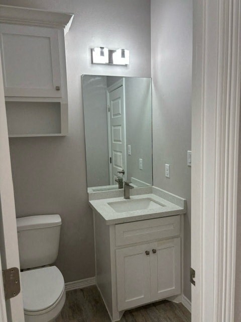 a bathroom with a sink toilet and a mirror