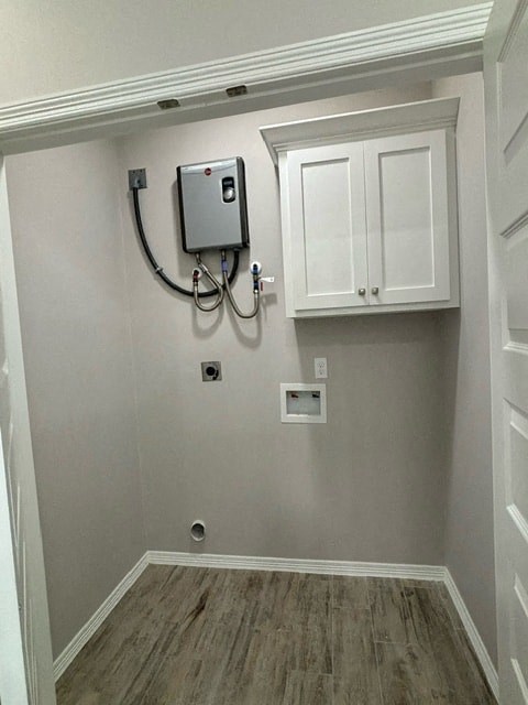 a wall with a monitor and a white cabinet
