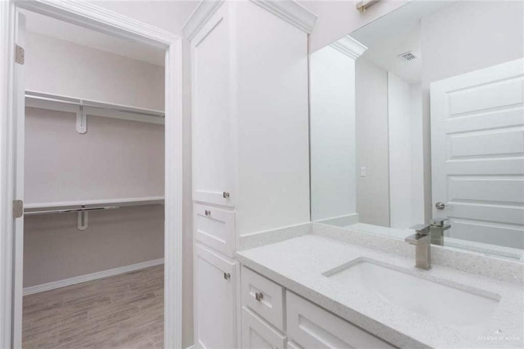 a white bathroom with a sink and a mirror