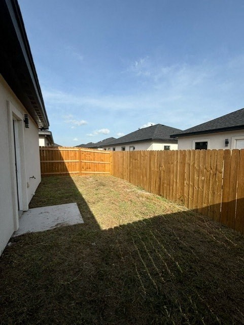 a backyard with a wooden fence and a house
