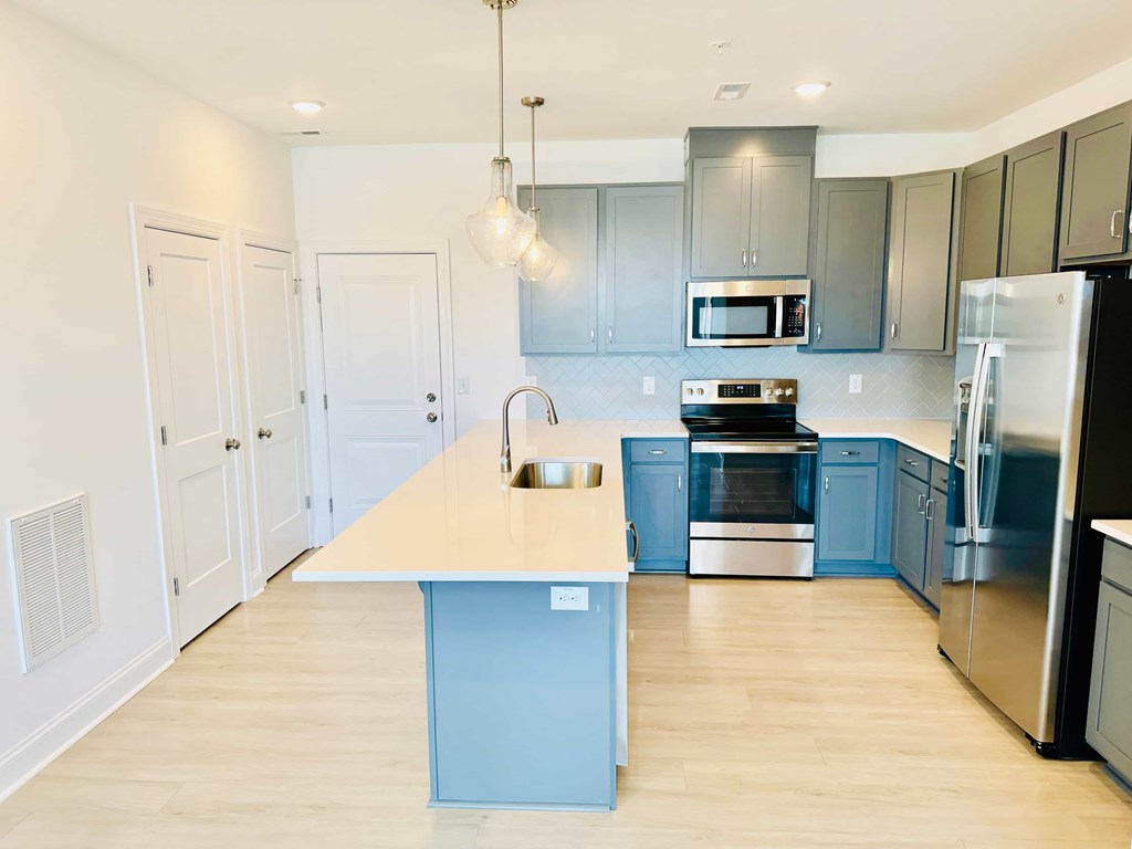 a blue and white kitchen with stainless steel appliances
