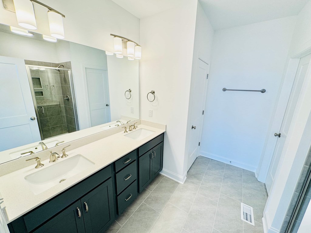 a bathroom with two sinks and a large mirror
