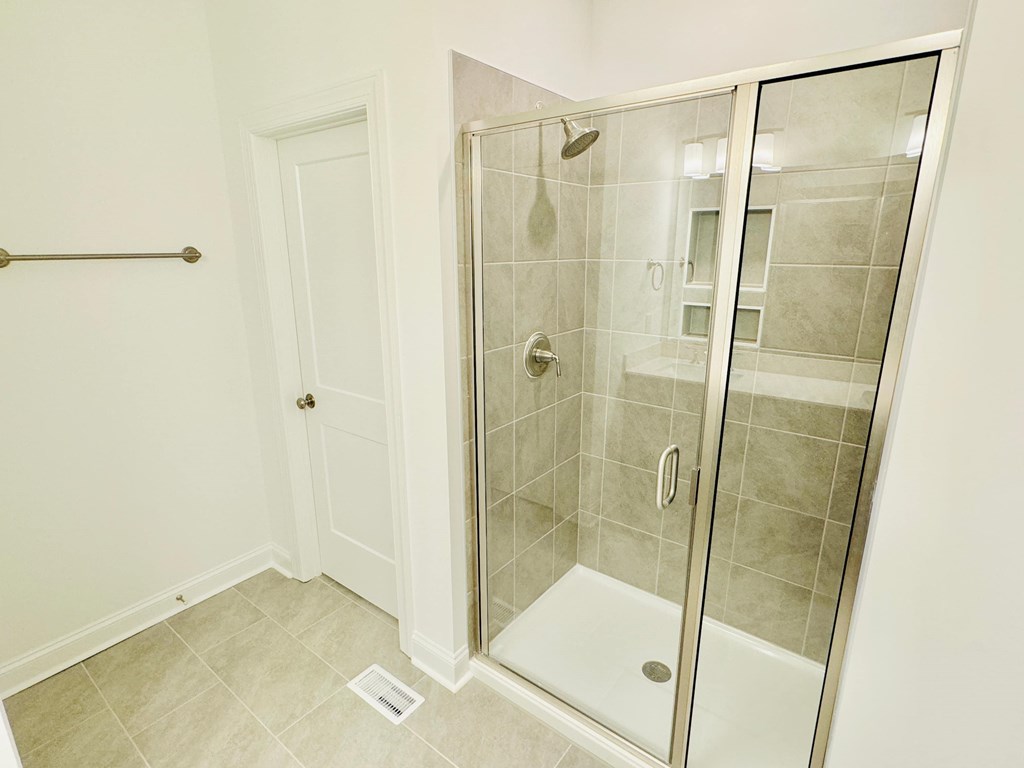 a bathroom with a shower and a door