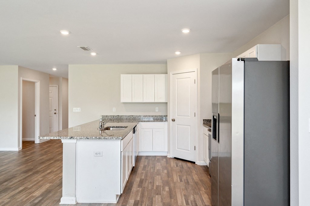 a renovated kitchen with white cabinets and stainless steel appliances