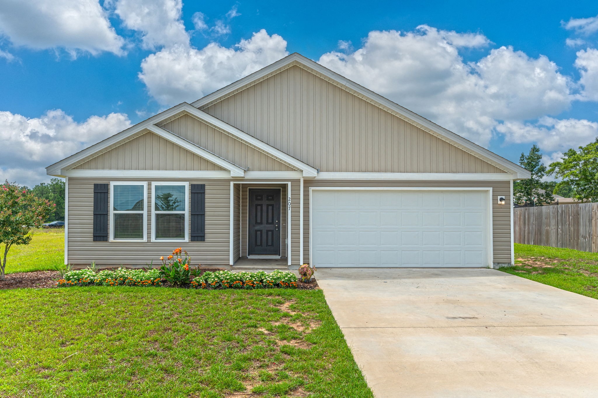 the front of a house with a driveway and a garage door