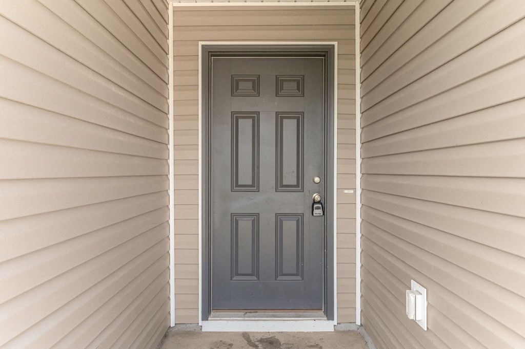 the front door of a home with a grey door