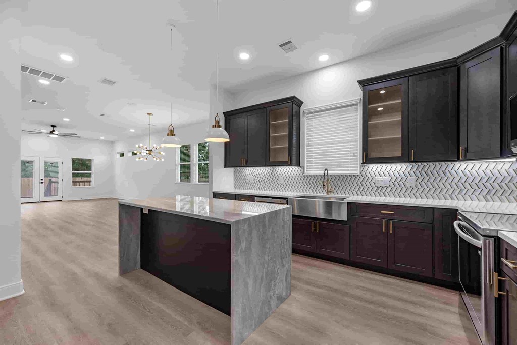 a large kitchen with a large island in the middle