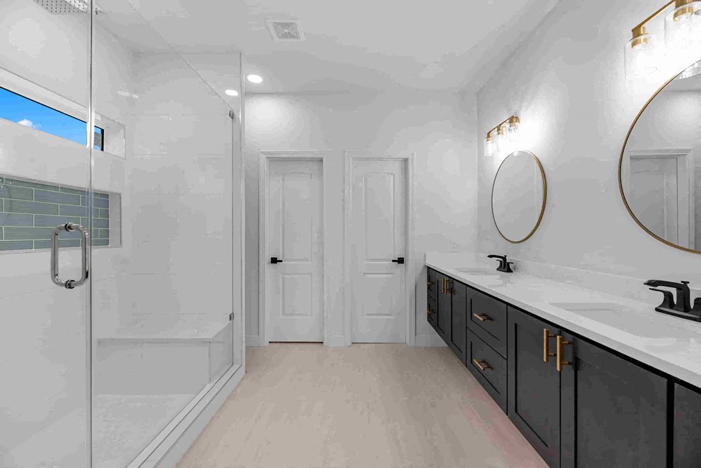 a bathroom with a shower and a sink and a mirror