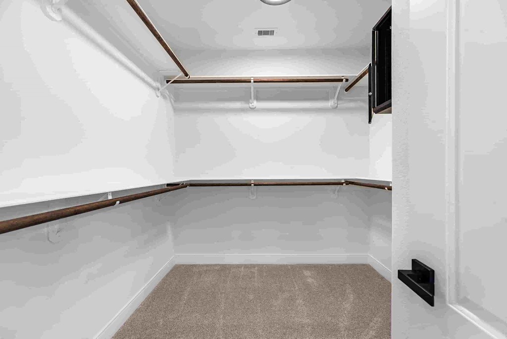 a empty basement room with white walls and a carpet