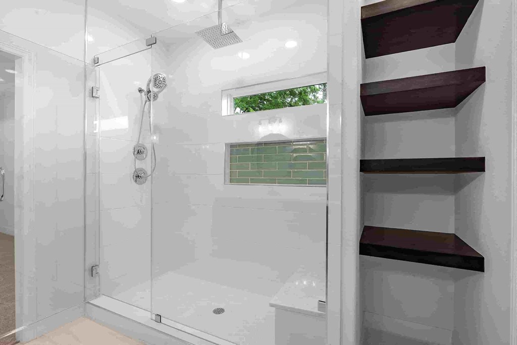 a bathroom with a shower and shelves in it