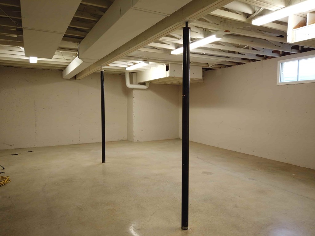 an empty room with tall poles in it