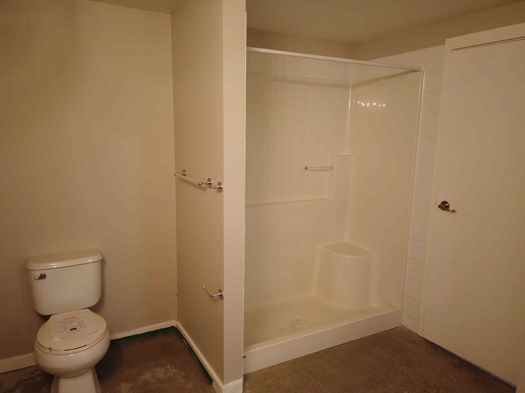 a small bathroom with a toilet and a shower