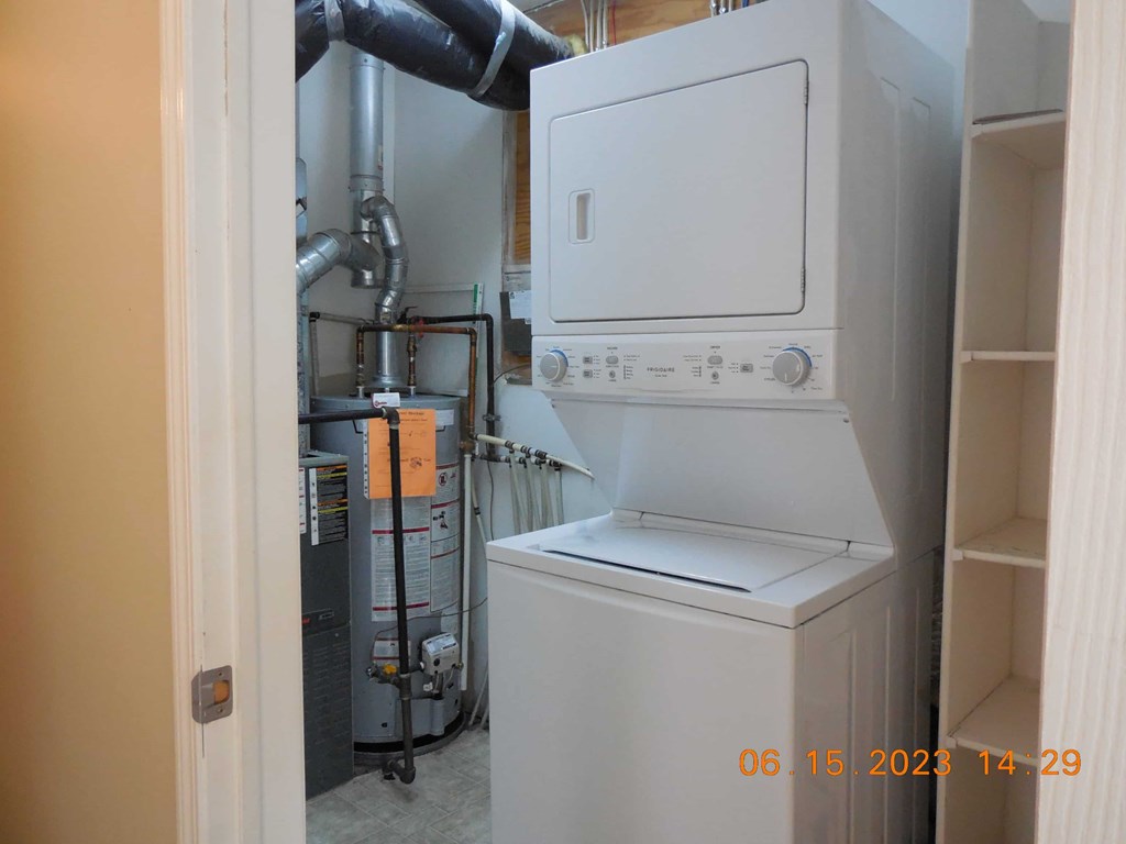 a white washer and dryer in a closet