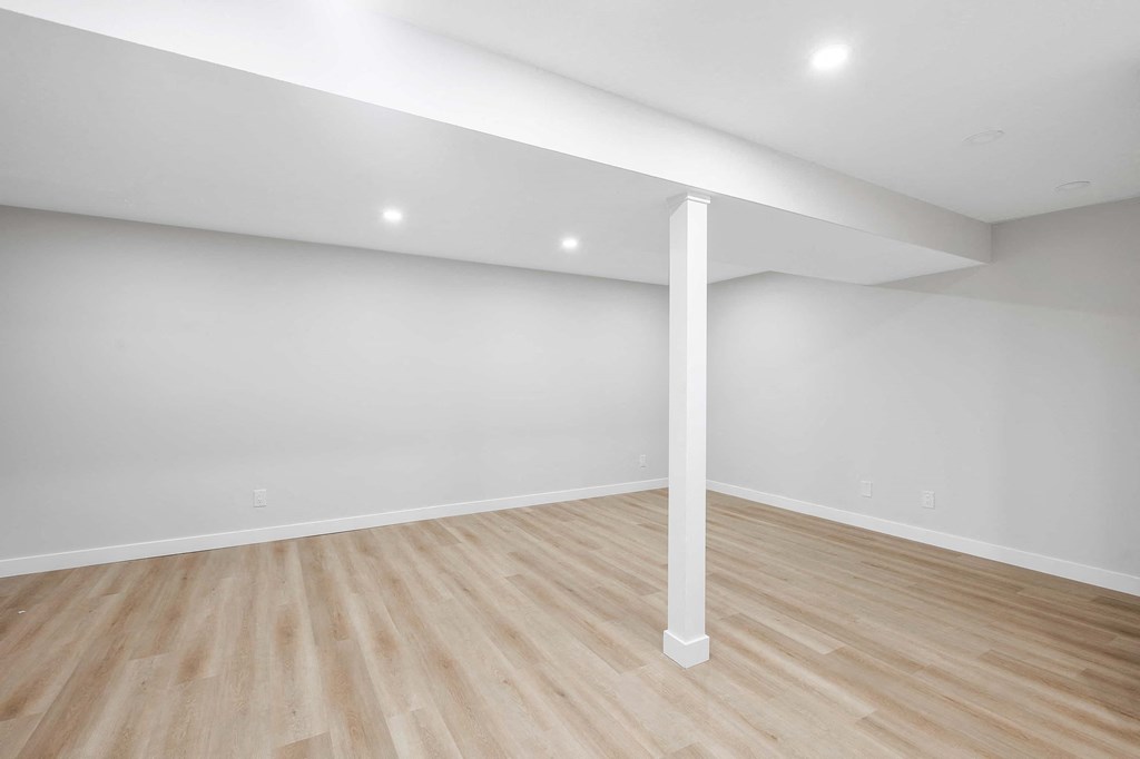 a room with white walls and wood floors
