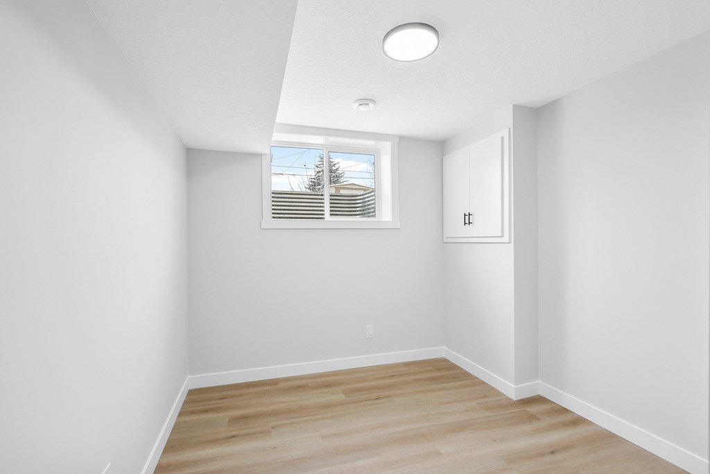 an empty room with white walls and a window