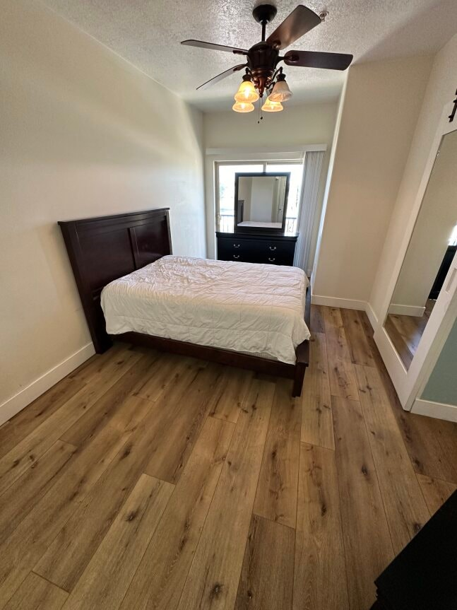 a bedroom with a bed and a ceiling fan