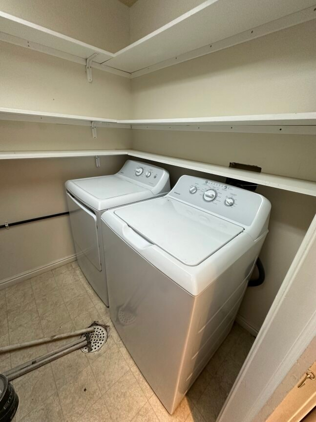 two washers and dryers in a laundry room