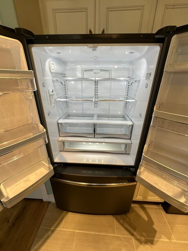 an empty refrigerator with its door open