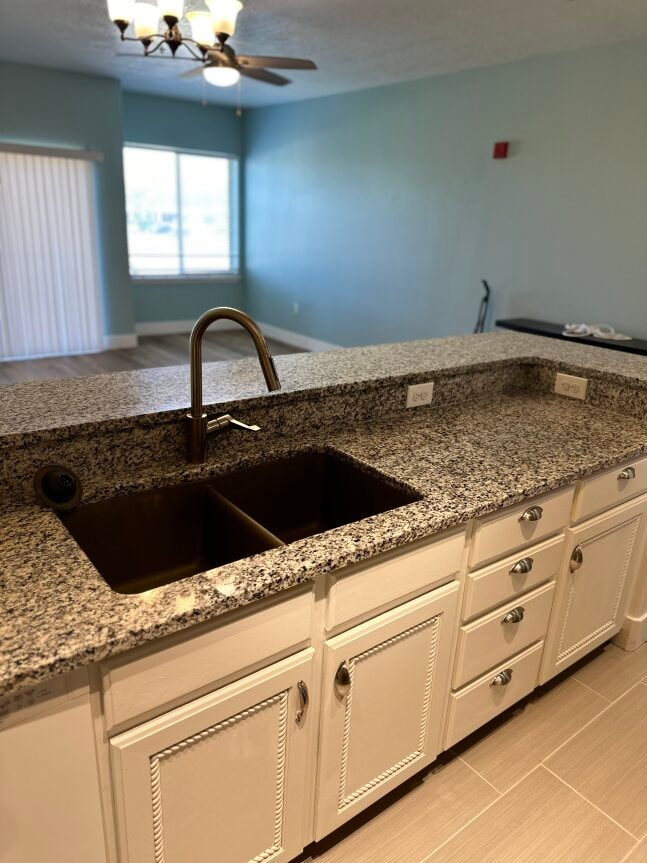 a kitchen with granite counter tops and a sink