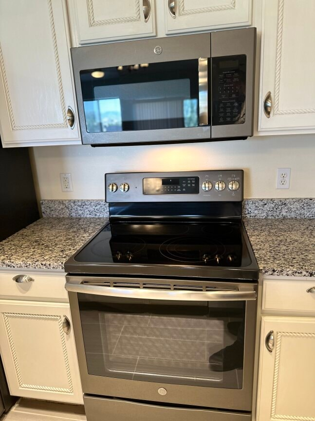 a kitchen with a stove and a microwave