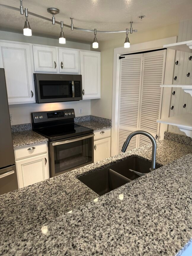 a kitchen with granite counter tops and a sink