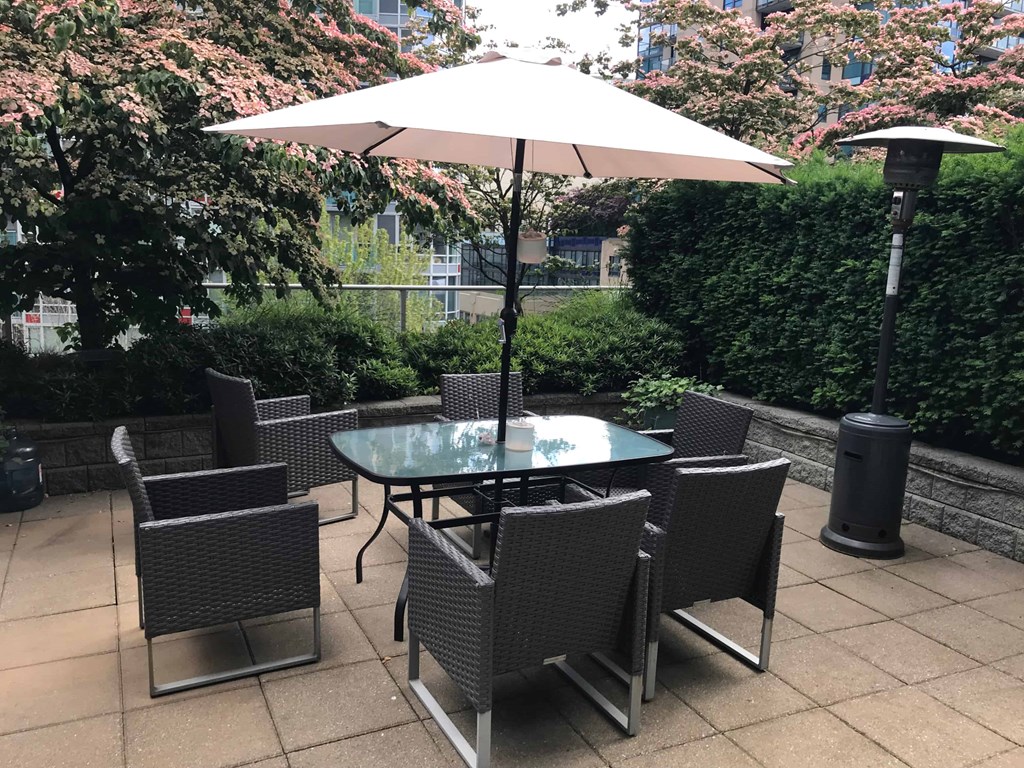 a table and chairs with an umbrella on a patio
