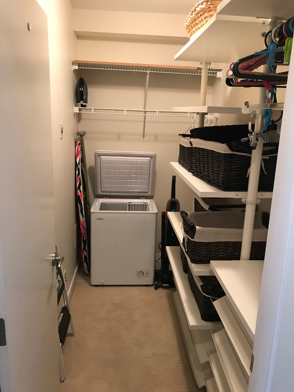 a walk in closet with a washer and dryer in it