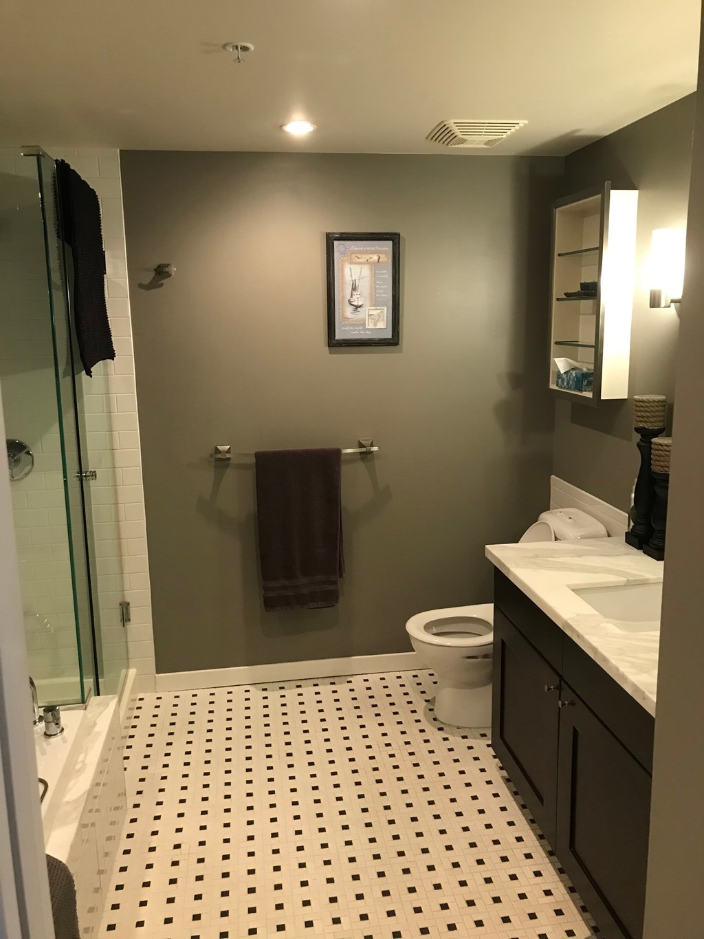 a bathroom with a toilet and a sink and a shower