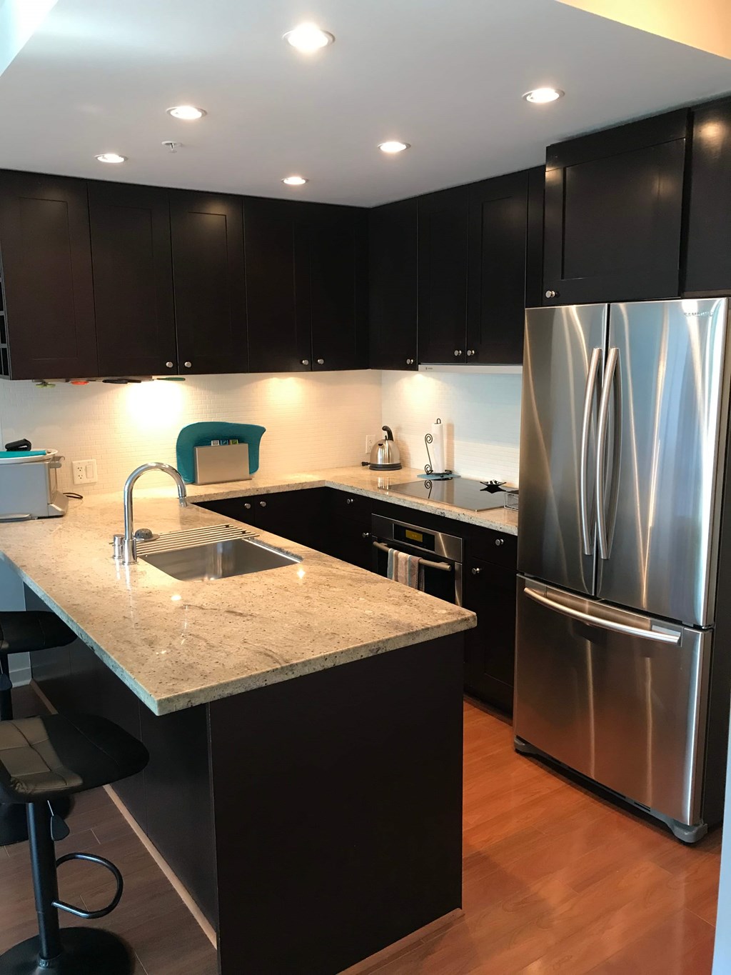 a kitchen with stainless steel appliances and black cabinets