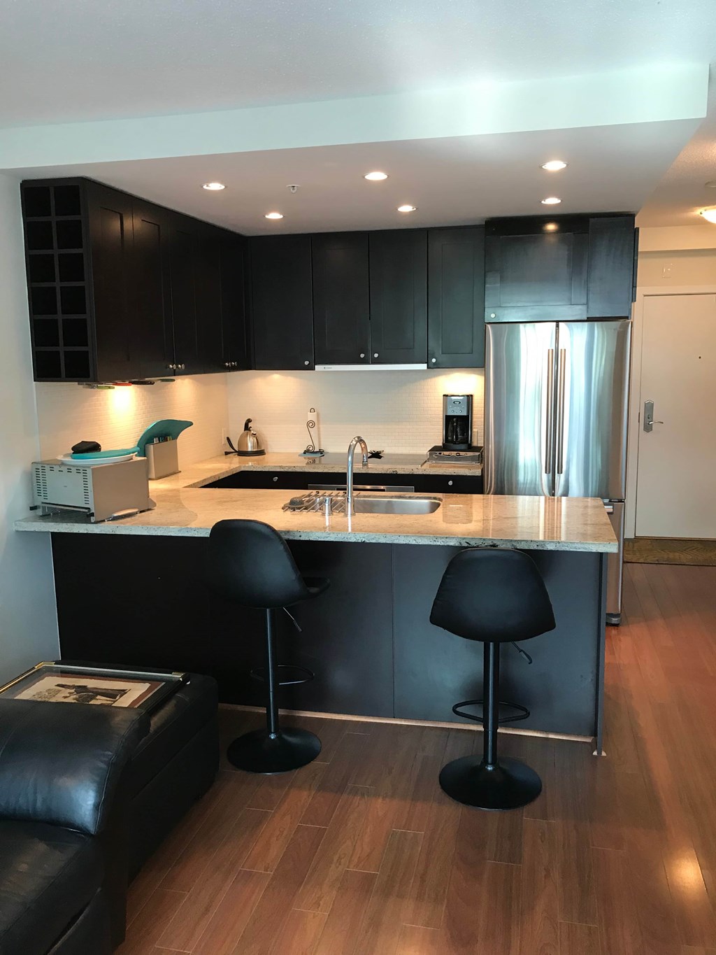 a kitchen with black cabinets and a counter top