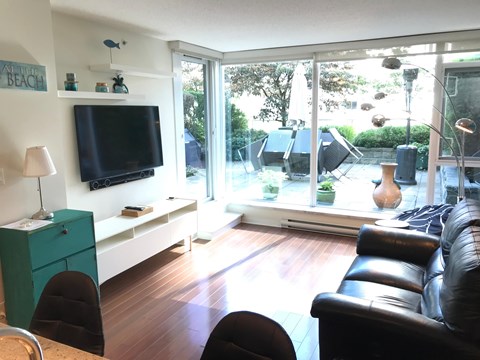 a living room with leather furniture and a tv