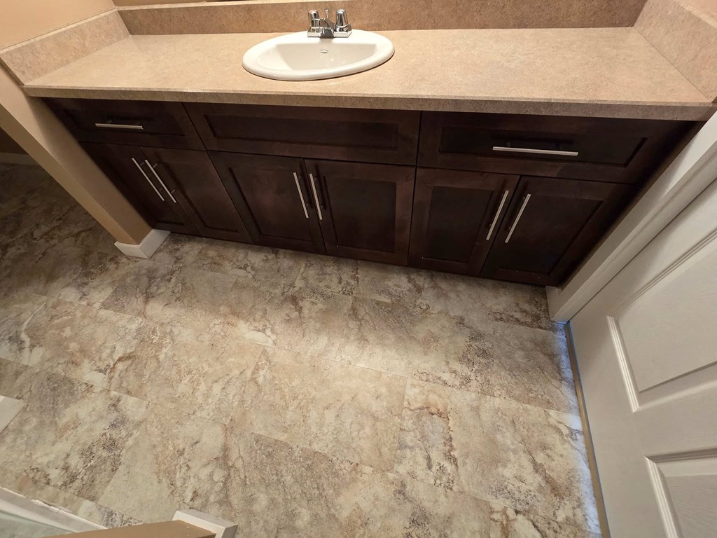 a bathroom with a sink and marble flooring