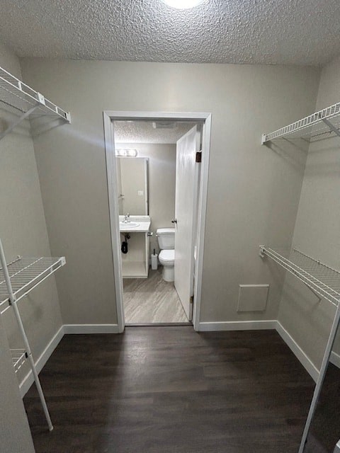 a bathroom with a toilet and a walk in closet